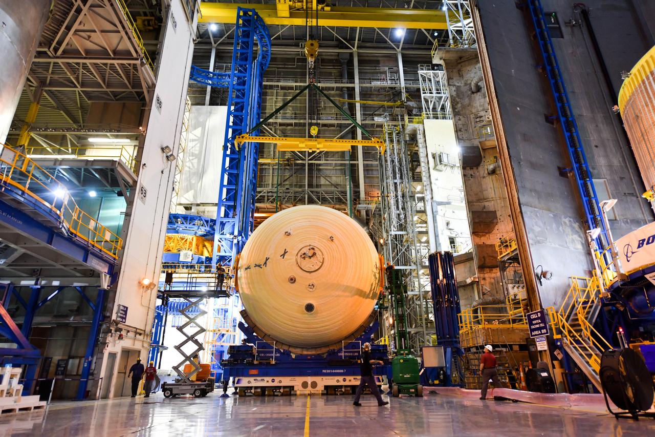 The Space Launch System (SLS) rocket’s liquid oxygen tank structural test article was manufactured and stacked in June 2019 at NASA’s Michoud Assembly Facility in New Orleans. To construct the test article, Boeing technicians at Michoud moved the liquid oxygen tank to the Vertical Assemby Building stacking and integration area. Here, they added simulators to mimic the two structures that connect to the tank, the intertank and the forward skirt.  This structural hardware for the SLS core stage for America’s new deep space rocket is structurally identical to the flight version of the tank. It will be shipped on the Pegasus barge to NASA’s Marshall Space Flight Center in Hunstville, Alabama, where it will undergo a series of tests that simulate the stresses and loads of liftoff and flight. These tests will help ensure designs are adequate for successful SLS missions to the Moon and beyond. The flight liquid oxygen tank along with the liquid hydrogen tank supplies more than 500,000 gallons of propellant to the core stages four RS-25 engines, which produce 2 million pounds of thrust to help send the SLS rocket to space.